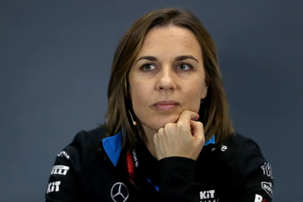 Claire Williams in Williams team kit, chin resting on her hand, listening in a press conference.