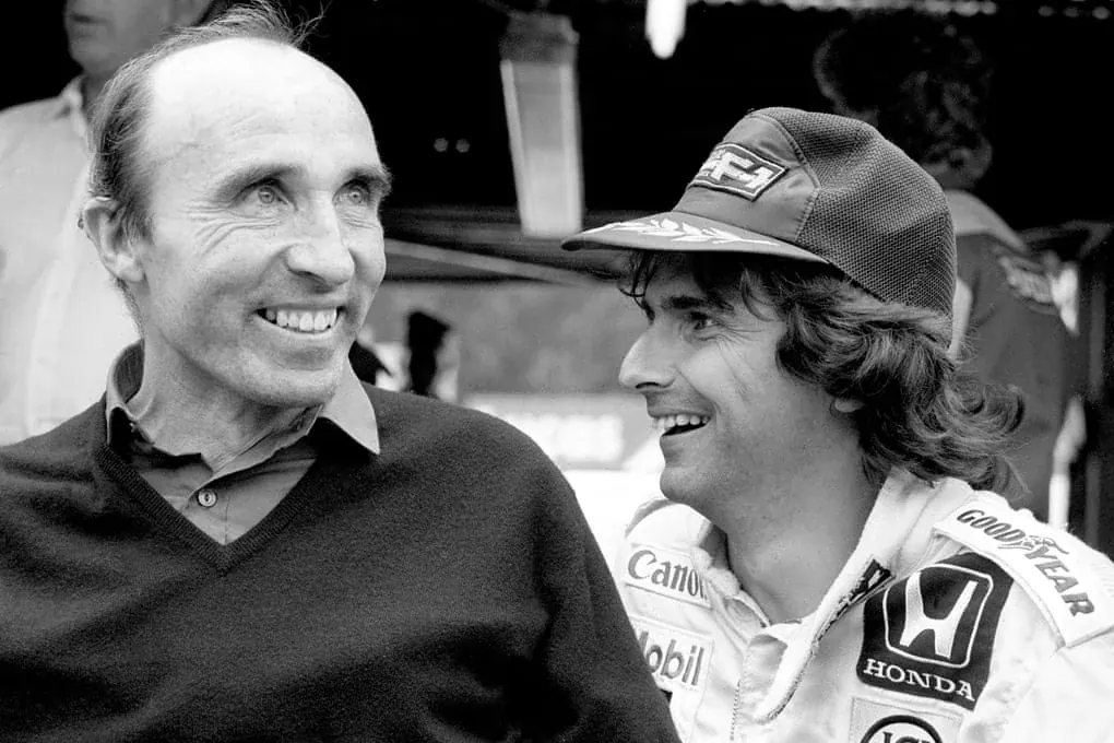 Frank Williams and Nelson Piquet smiling together in 1986.